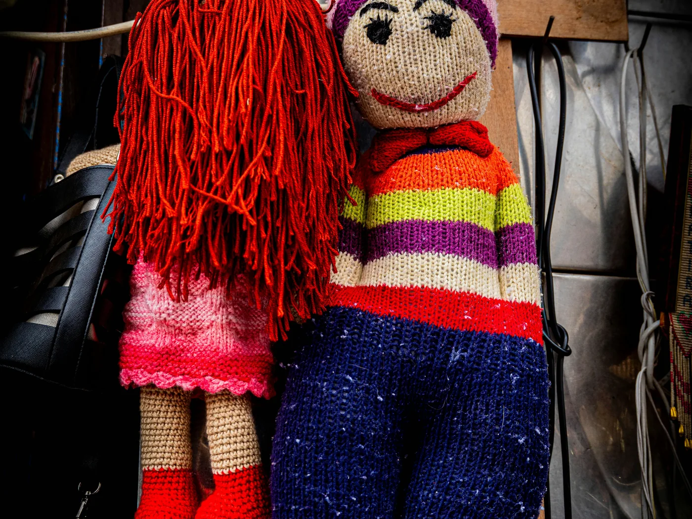 Pair of colorful handmade cloth dolls in traditional dress.