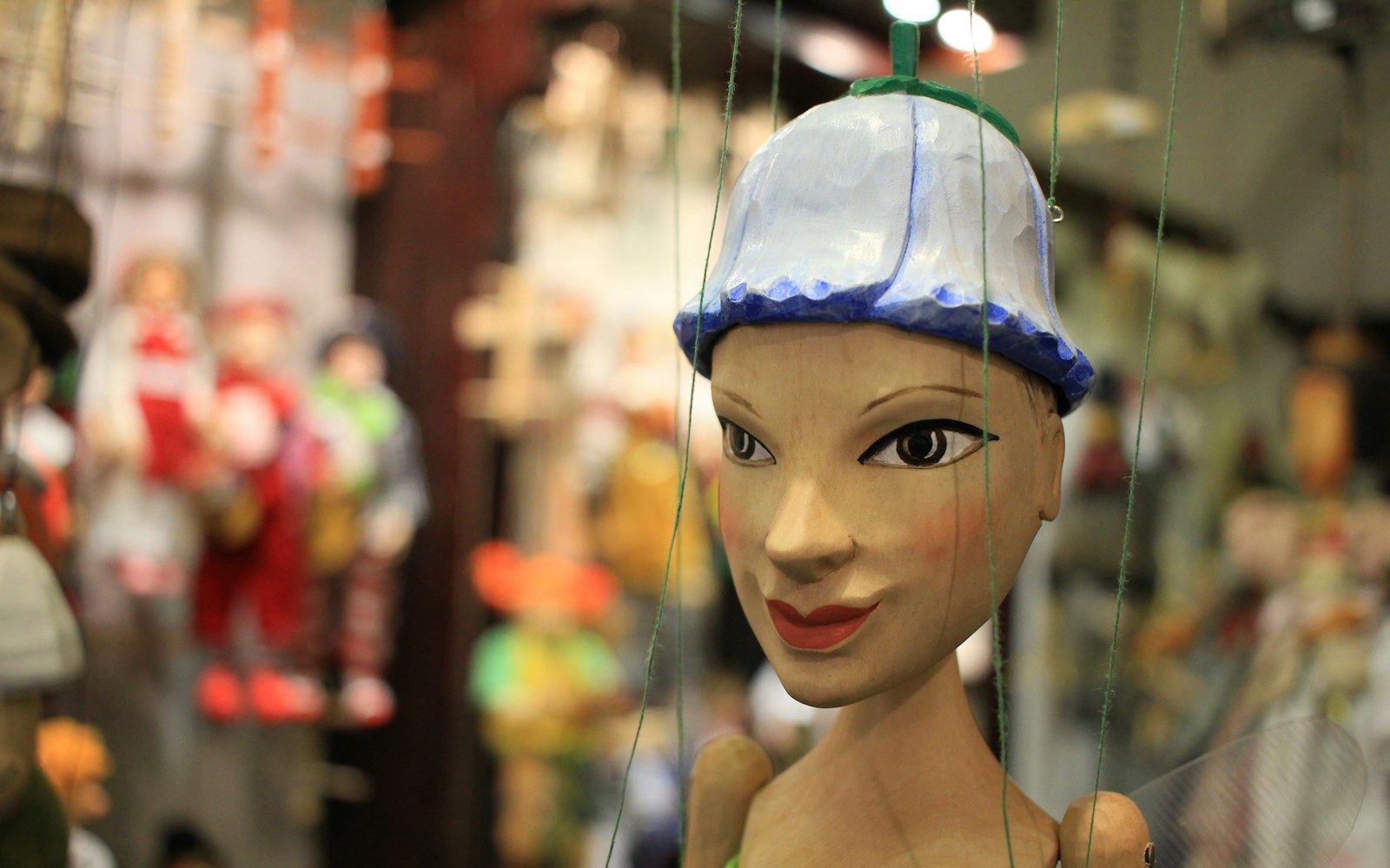 Close-up of a wire armature for an art doll with twisted spine and loop joints, partially wrapped in natural core wool.