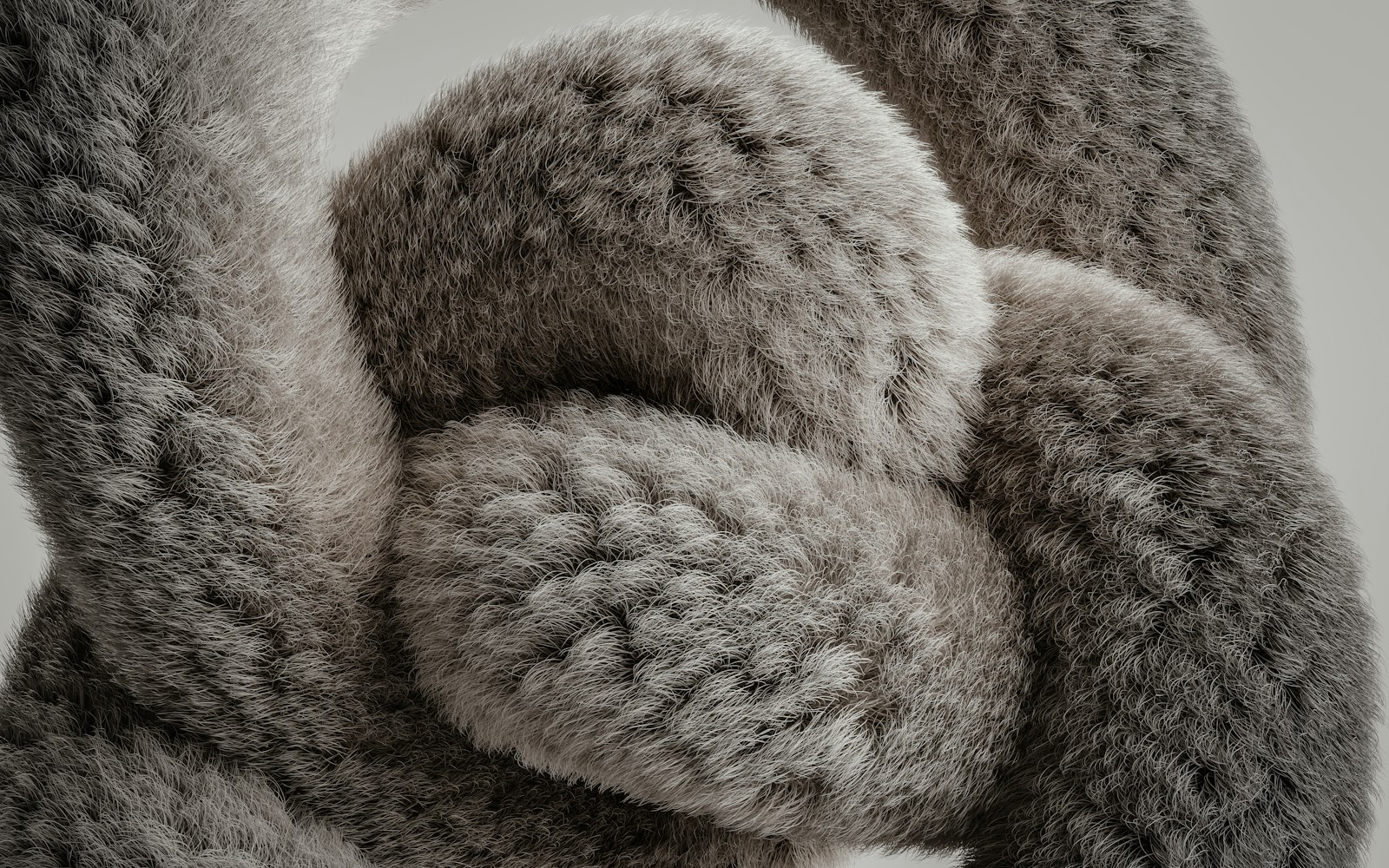 A small needle-felted wool animal sculpture resting on acid-free tissue beside a roomy archival storage box in soft indirect light.