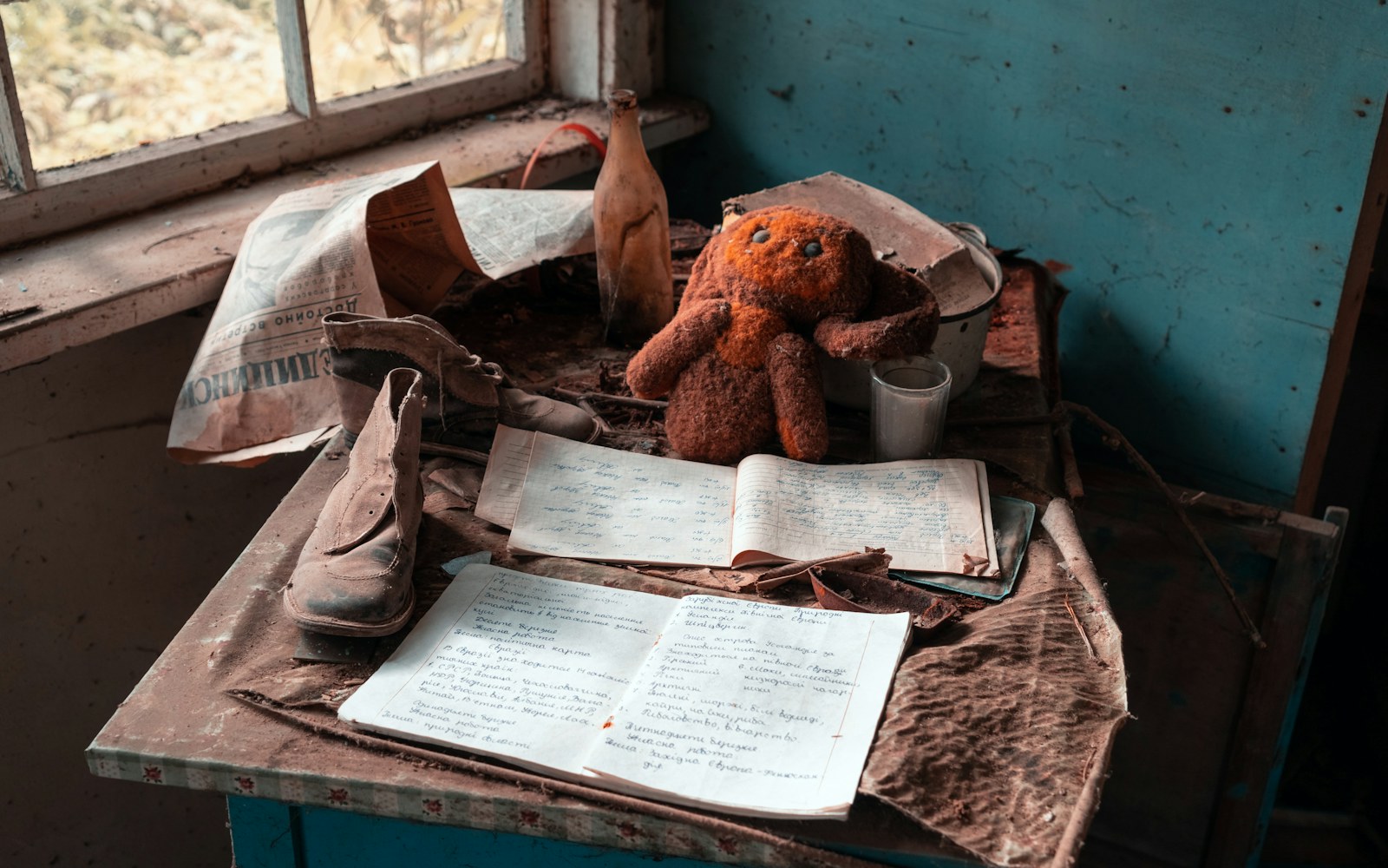 Close-up of a vintage plush bear with visible wear, alongside a partially restored similar bear, showing the contrast between original patina and fresh repair.