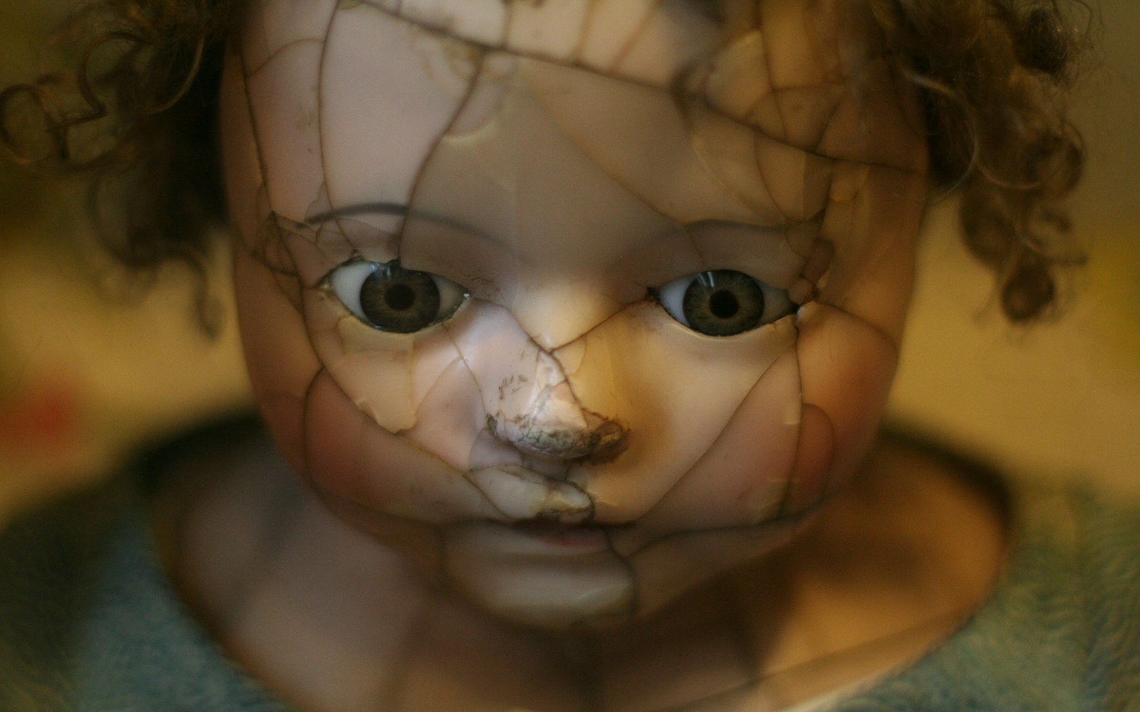 A collector carefully examining a vintage plush doll with a small tear in the fabric, restoration tools nearby