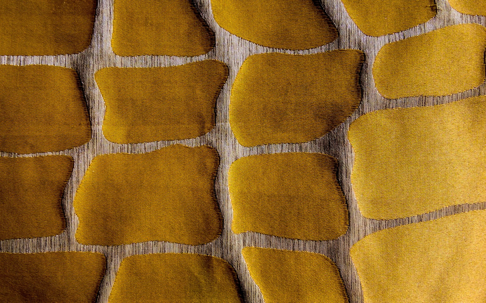Close-up of a scaled plushie pattern grid overlay on graph paper with fabric swatches